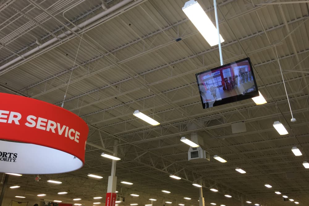 Live HD security camera monitor displayed at retail store entrance